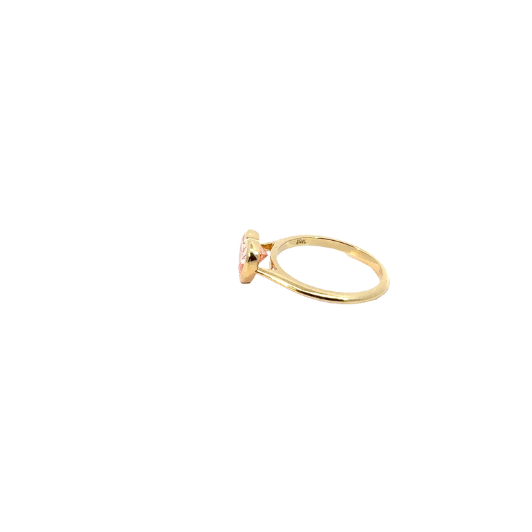 A heart-shaped lab-grown diamond bezel solitaire ring in yellow gold.