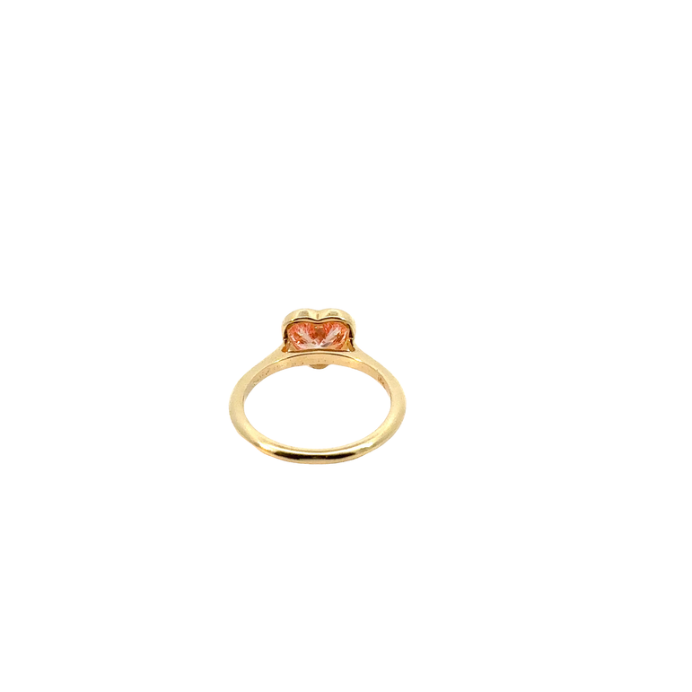 A heart-shaped lab-grown diamond bezel solitaire ring in yellow gold.