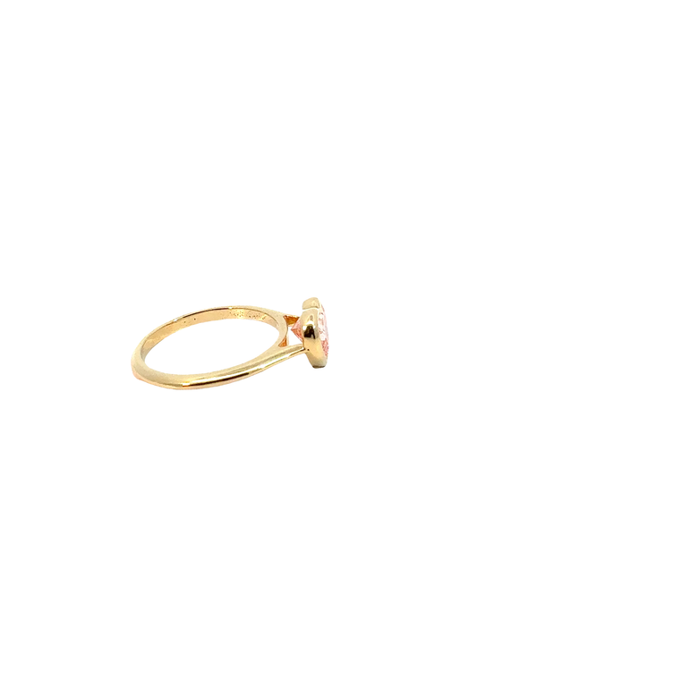 A heart-shaped lab-grown diamond bezel solitaire ring in yellow gold.