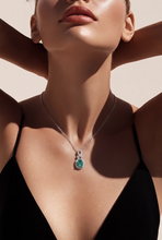 Oval Emerald and Diamond Halo Pendant Necklace in White Gold