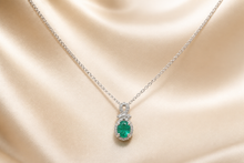 Oval Emerald and Diamond Halo Pendant Necklace in White Gold