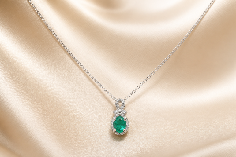 Oval Emerald and Diamond Halo Pendant Necklace in White Gold