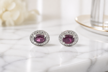 Oval Purplish-Red Ruby Halo Stud Earrings in White Gold